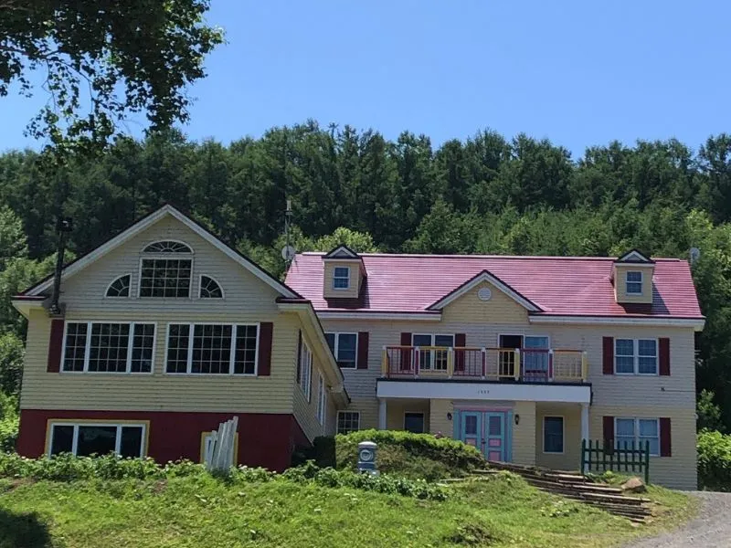 A cozy and welcoming guesthouse nestled in a beautiful natural landscape, representing our origins.