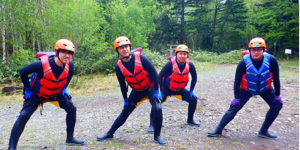 A group of adventurers doing warm-up stretches, preparing their bodies for the challenging course ahead.