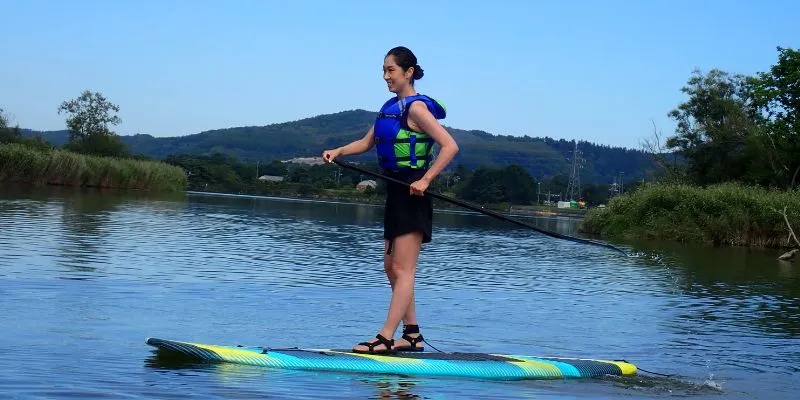 Relaxing on a SUP board on a calm lake.