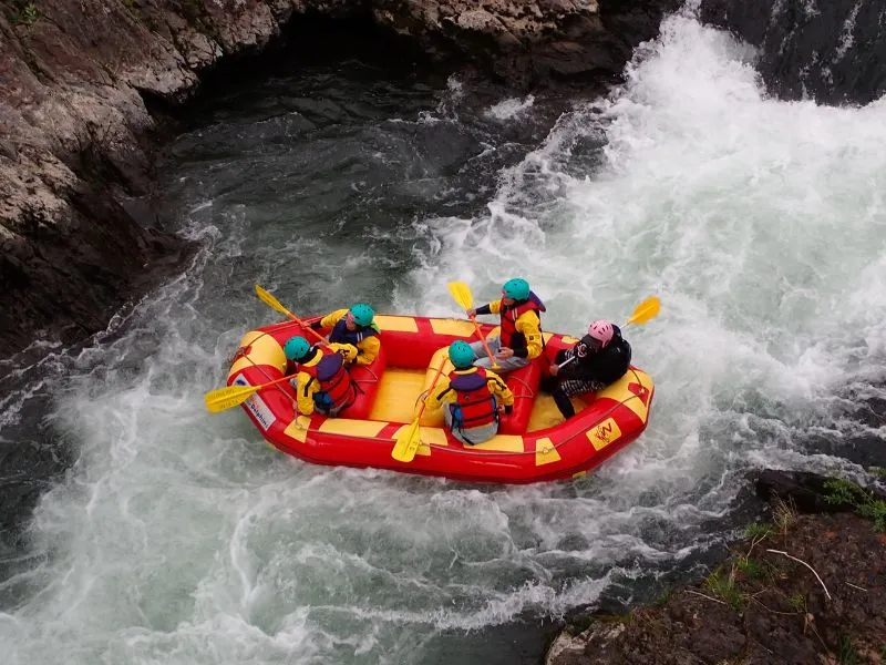 A guide carefully checking a participant's helmet and life jacket before the tour begins.
