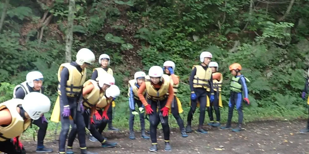 Participants listening to a guide's safety briefing and instructions before entering the canyon.