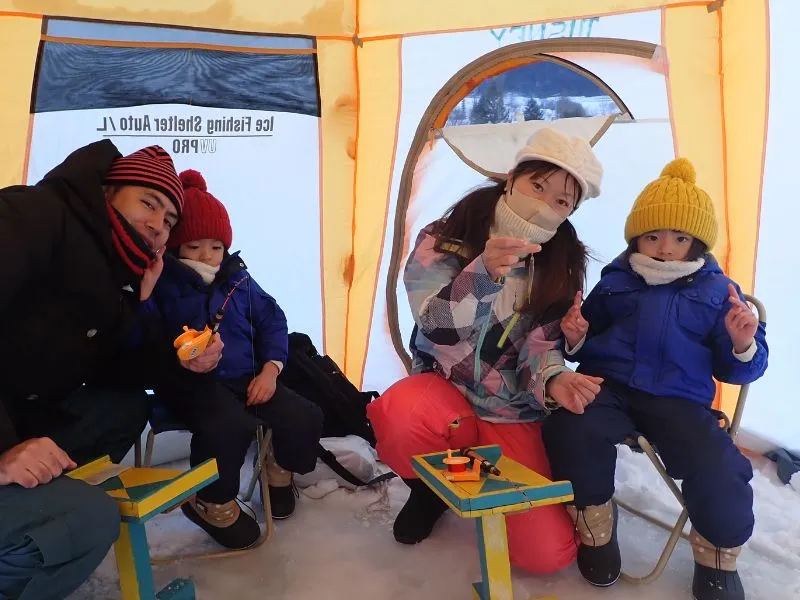 A complete set of ice fishing gear ready for use.