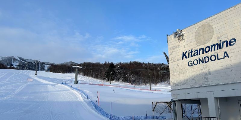 A selection of modern skis and snowboards available for rent.